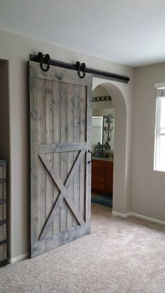 an open barn door in the middle of a room