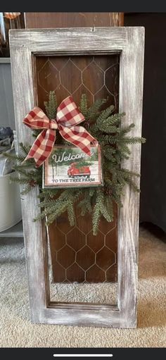 a wooden frame with a red and white bow on it