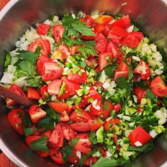 a large metal bowl filled with chopped vegetables