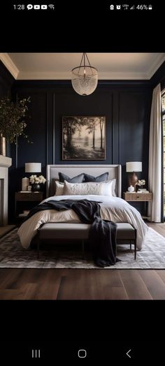 a bedroom with dark blue walls and white bedding in the center is a chandelier