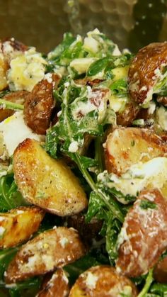 a salad with potatoes, cheese and spinach