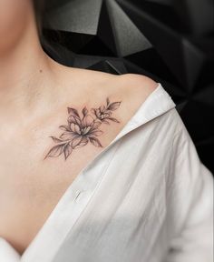 a woman with a flower tattoo on her chest