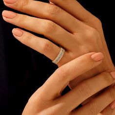 a woman's hands with two different rings on their fingers and one is holding the other