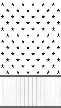 black and white stars are on the side of a wooden wall with wood slats