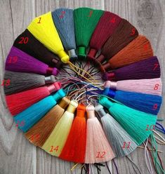 colorful tassels arranged in a circle on a wooden surface