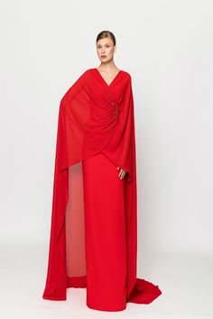 Elevate your elegance with the Naja Saade RTW23-35 v-neck crepe long dress. Adorned with intricate embroidery and a stylish overlapped cape, this dress exudes sophistication and grace. Perfect for special occasions where you want to make a statement. Dress Cape, Milly Dresses, Plastic Dress, Valentino Red, Cape Style, Fancy Dresses Long, Modest Style, Dress Design Sketches, Cape Dress