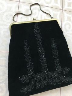 "1980s does 1930s Art Deco style with this gorgeous velvet evening bag. Black-on-black beading adds glamour. Fully lined in black satin with small card pocket. Antique look bronze hardware. Excellent condition. Size: 7.5\" x 9.5\" x 10.5\"." Black Velvet Evening Bag For Formal Occasions, Black Victorian Bag For Vintage Events, Victorian Style Black Bag For Vintage Events, Handmade Victorian Evening Bag, Black Victorian Style Bags For Formal Occasions, Handmade Velvet Evening Bags, Black Victorian Style Formal Bag, Antique Black Evening Bags, Vintage Handmade Evening Bag