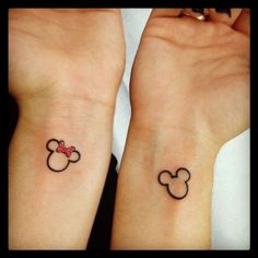 two wrist tattoos with mickey and minnie mouse ears on them