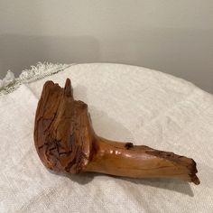 a piece of wood sitting on top of a white cloth