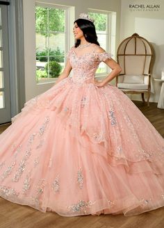 This dress is meant to make any young lady feel like a princess from a fairy tale; it is whimsical and romantic. This event will be exceptionally memorable thanks to the enchanting look created by a glitter tulle fabric and a cold shoulder neckline. The piece has an extra dose of girlish charm from the layered ruffles and an extra sparkle from the beading and applique details. The lace-up back of this dress is a striking detail. The last bit? The dreamlike ensemble is completed with matching glo Long Ball Gown, White Dress Styles, Red Quinceanera Dresses, Black Ball Gown, Emerald Bridesmaid Dresses, Quinceanera Dresses Pink, Green Homecoming Dresses, White Homecoming Dresses, Plus Size Cocktail Dresses