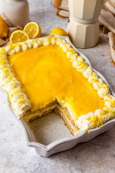 a lemon tart cake with one slice cut out and the rest on the table