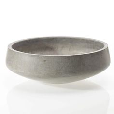 a metal bowl sitting on top of a white table