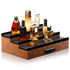 an assortment of perfumes on a wooden tray