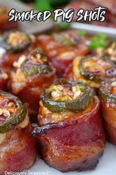 some food is on a white plate with the words smoked pig shots above it and an image of bacon wrapped in green peppers