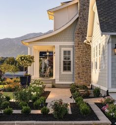 a house that has some flowers in front of it