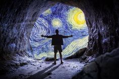 a man is standing in the middle of a tunnel with his arms wide open and painted like a starry night