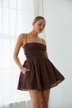 Fall in love with the Eliza Open Back Mini Dress! This fit and flare mini dress features a smocked bodice, open back, side pockets! Available in Chocolate Brown; style this linen mini dress with a pair of Cowboy Boots to polish off the outfit! Details: 100% Cotton Lots of Stretch Fully Lined Adjustable Straps Elastic Waistband 2 Side Pockets Hand Wash Cold/ Line Dry Fit And Flare Mini Dress, Red Floral Top, Open Back Mini Dress, Brown Mini Dress, Rush Dresses, Brown Style, Linen Mini Dress, Flare Mini Dress, Prom Party Dresses