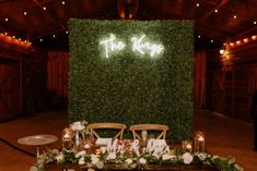 the reception table is set up with white flowers and greenery