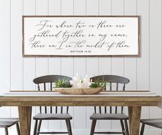 a dining room table with two chairs and a sign above it that says for those one who is there are gathered together on my name