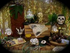 a table topped with lots of skulls and other items on top of a wooden crate