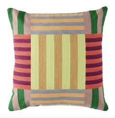 a multicolored striped pillow on a white background