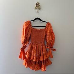 Caroline Constas Finley Orange Dress M Condition: Like New, No Signs Of Wear Color: Medium Size: M Measurements Are Approximate; Taken While Garment Is Lying Flat: Smocked Top Fits From 12-18 Across Chest And Waist, 30" Length Other Features: The Finley Minidress From Caroline Constas Has A Flattering Shirred Bodice Framed By Puffed Sleeves. It's Made From A Polka-Dot Cotton-Blend With A Tiered Skirt. Dc-B11 Caroline Constas, Smocked Top, Puffed Sleeves, Orange Dress, Tiered Skirt, Orange Yellow, Medium Size, Smocking, Puff Sleeve