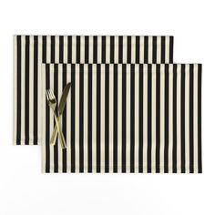 black and white striped placemats with gold cutlery on each side, set of two