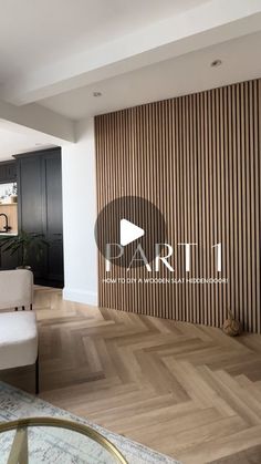 a living room filled with furniture next to a wall covered in wooden slats and a white couch