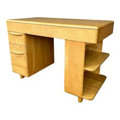 a wooden desk with three drawers on one side and two open shelves on the other