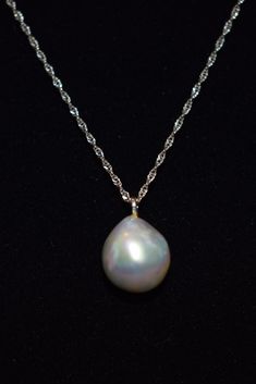 "Here is gorgeous light gray/ blue natural baroque pearl pendant necklace. The 14k white gold diamond cut chain measures 18\" and the baroque pearl is nearly 4 carats! The camera just cannot translate the absolutely beautiful iridescence of this pearl. It is full of pastel gray, blue and pink and measures 12 x 10 mm The pearl was purchased in Hawaii and has never been worn. The white gold chain has been added to allow for immediate wear." White Gold Drop Pearl Necklace, Silver Teardrop Akoya Pearl Jewelry, Formal Drop Pearl Necklace In White Gold, Formal Drop White Gold Pearl Necklace, Formal Drop-shaped White Gold Pearl Necklace, Formal Tahitian Pearl Pendant Jewelry, White Gold Briolette Pearl Pendant Necklace, Silver Single Strand Pear-shaped Necklaces, High Luster Akoya Pearl Briolette Jewelry