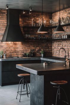 an industrial kitchen with brick walls and black counter tops, bar stools in front of the island