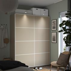 a bedroom with a bed, chair and sliding closet doors that are open to let in light