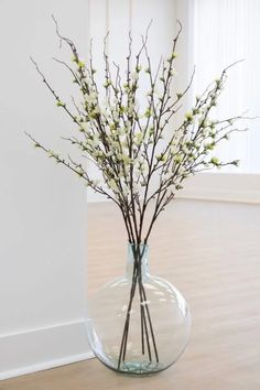 a vase filled with white flowers on top of a wooden floor