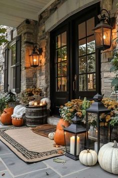 a front porch decorated for fall with pumpkins and gourds