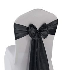 the back of a chair with a black bow on it's sashel and seat cover