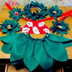 three pieces of paper on top of a wooden table with scissors and other crafting supplies