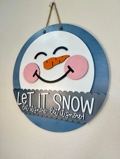 a sign that says let it snow be happy and bright on the front of a white wall