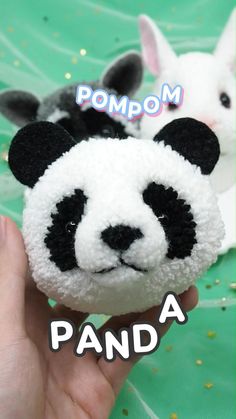 there is a small stuffed panda bear in the hand