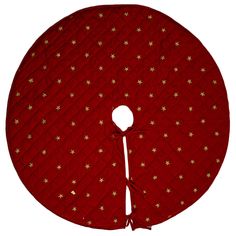 a round red table cloth with gold stars on it