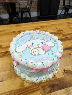 there is a birthday cake that looks like a bunny on top of the table with confetti and sprinkles