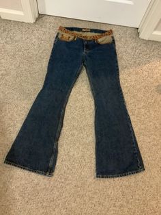 This nice pair of vintage 90s does 70s bell bottom patchwork low waist denim boho festival jeans comes to you in a marked size of 7. Pls compare the measurements I give you to those in your closet. The waistband has a cool floral detail and then gold piping on top of the pockets trim detail. Sold that way. The lower waist is approx 14 1/2 inches-rise is 8 1/2 inches-31 inches inseam-19 1/2 to 19 3/4 inches hips. Wide-leg Jeans For Fall Festival, Wide Leg Jeans For Fall Festival, Fall Festival Denim Flare Jeans, Hippie Style Denim Flare Jeans For Festivals, Bohemian Denim Flare Jeans For Fall, Bohemian Flare Denim Jeans For Fall, Bohemian Flare Denim Jeans, Bohemian Mid-rise Flare Jeans In Medium Wash, Fitted Flare Jeans For Festival