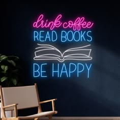 a neon sign that says drink coffee read books be happy on the wall next to a chair