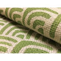 the fabric is green and white with an intricate design on it's side,