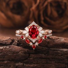 a close up of a ring on a piece of wood with roses in the background