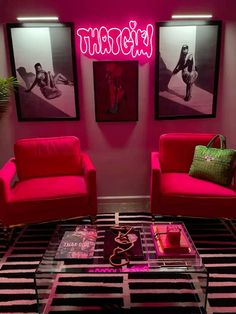 a living room with two red chairs and a coffee table