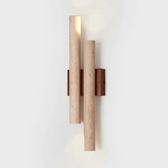 the wall light is made out of wood and has two tubes attached to it's sides