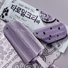 a purple popsicle sitting on top of a table next to a bar of soap