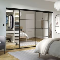 an image of a bedroom setting with mirrored closet doors