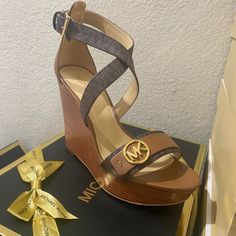 This Sandal Will Take Any Look To Striking New Heights. Crossover Straps Elegantly Frame The Foot, While A Wedge Heel And Sturdy Platform Add Height Without Sacrificing Comfort. I Love How The Gilded Logo Adds A Hint Of Shine To Any Ensemble! Wedge Sandal Faux Leather/Logo-Print Canvas 100% Polyurethane Lining: Polyurethane Blend Sole: Rubber Open Toe Buckle Fastening Heel Height: 4” Platform Height: 1” Heel Type: Stacked Imported Brown High Heel Wedge Sandals In Synthetic Material, Brown High Heel Wedge Sandals In Synthetic, Brown High Heel Synthetic Wedge Sandals, Brown High Heel Wedge Sandals With Heel Strap, Brown Synthetic Wedge Sandals With 4-inch Heel, Brown Wedge Sandals With Heel Strap, Brown High-heel Wedge Sandals With Heel Strap, Brown Wedge Sandals With Cushioned Footbed, Brown Synthetic Wedge Heels