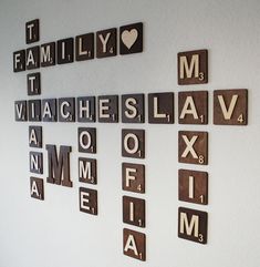 scrabble tiles are arranged in the shape of letters and numbers on a wall